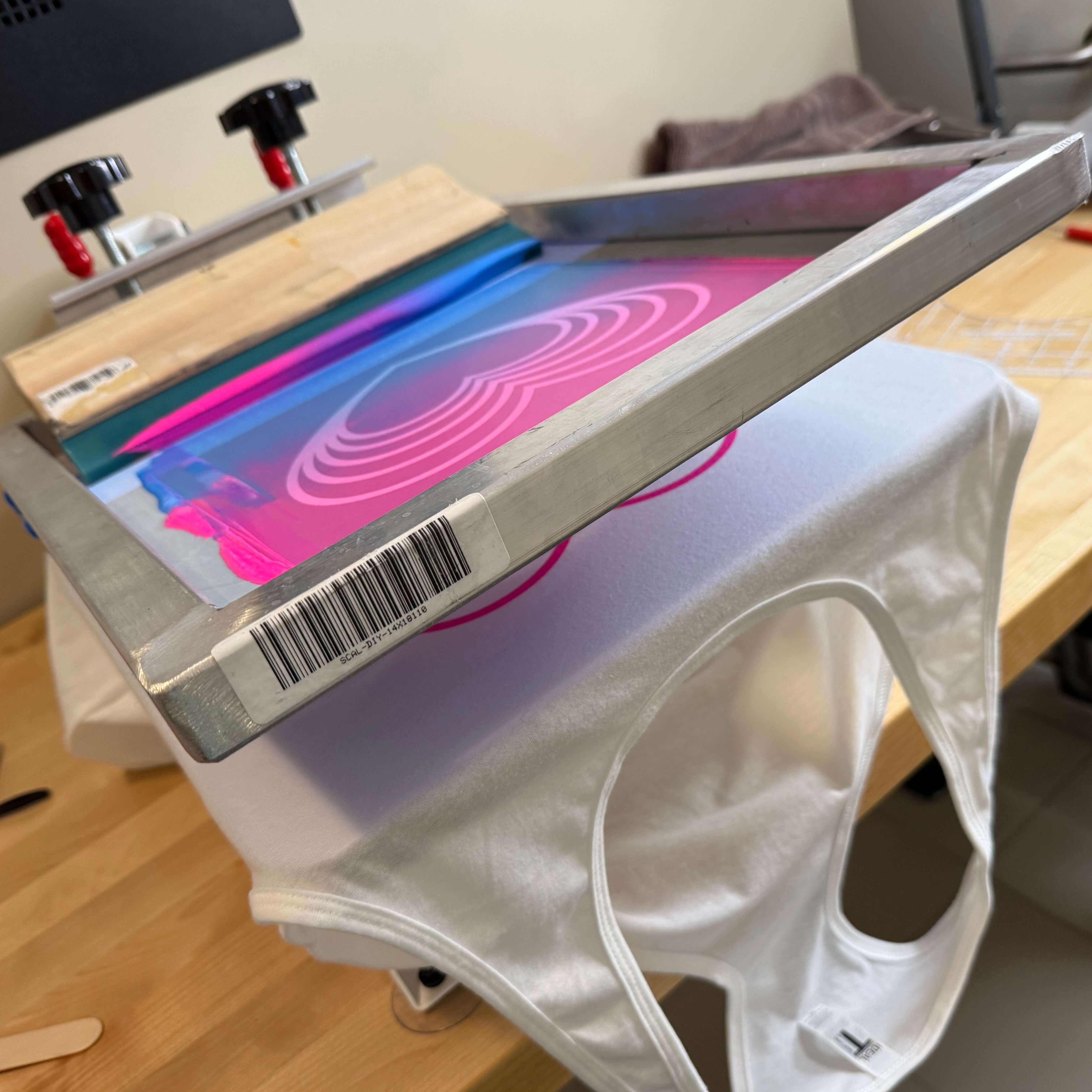 Finished Los Místicos tee held up after printing